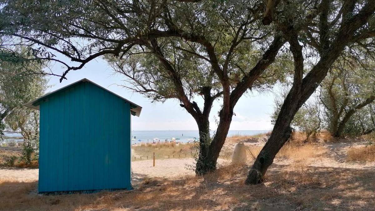 Capanni balneari in riva al mare e una manifestazione di protesta