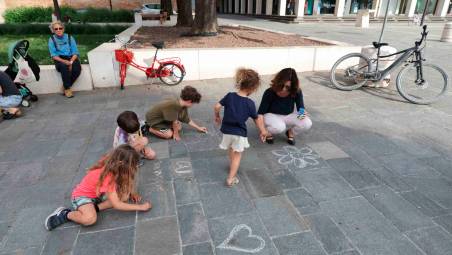 Bambine e bambini impegnati coi gessetti in piazza Bufalini