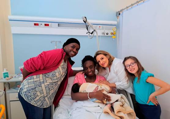 La piccola Fatima in braccio alla mamma insieme alle altre protagoniste di questa storia a lieto fine